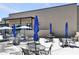 Outdoor patio area with tables, chairs, and umbrellas for shade at 7705 E Doubletree Ranch Rd # 56, Scottsdale, AZ 85258