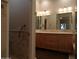 Bathroom with double vanity, large mirror, and shower at 7741 E Balao Dr, Scottsdale, AZ 85266