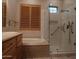 Spa-like bathroom with soaking tub, walk-in shower, and wood shutters at 7741 E Balao Dr, Scottsdale, AZ 85266