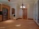 Bright dining room with hardwood floors, chandelier, and access to kitchen and laundry at 7741 E Balao Dr, Scottsdale, AZ 85266