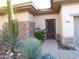 Front entrance with wrought iron gate and desert landscaping at 7741 E Balao Dr, Scottsdale, AZ 85266