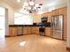 Spacious kitchen, featuring stainless steel appliances and light wood cabinets at 7741 E Balao Dr, Scottsdale, AZ 85266