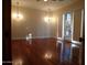 Spacious living room featuring hardwood floors and elegant chandeliers at 7741 E Balao Dr, Scottsdale, AZ 85266