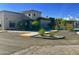 Beige stucco building with red tile roof, blue accents and parking lot at 7750 E Broadway Rd # 400, Mesa, AZ 85208