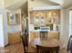 Cozy dining area featuring wood-look floors, a table with chairs, and plenty of cabinet space at 7750 E Broadway Rd # 400, Mesa, AZ 85208