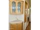 View of kitchen with wood cabinetry including glass-door cabinets, corner countertops, and a doorway at 7750 E Broadway Rd # 400, Mesa, AZ 85208