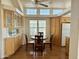 Cozy breakfast nook with a round wood table and cabinets underneath clerestory windows at 7750 E Broadway Rd # 400, Mesa, AZ 85208