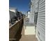 A walkway provides access to the home, with gray metal railings and a brick pathway between manufactured homes at 7750 E Broadway Rd # 400, Mesa, AZ 85208