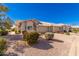 Tan stucco home with a two-car garage and desert landscaping at 7928 E Pueblo Ave # 62, Mesa, AZ 85208