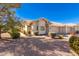 Tan stucco home with a two-car garage and desert landscaping at 7928 E Pueblo Ave # 62, Mesa, AZ 85208