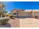 Tan stucco home with a two-car garage and desert landscaping at 7928 E Pueblo Ave # 62, Mesa, AZ 85208