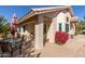 Covered patio with seating area and vibrant flowers at 7928 E Pueblo Ave # 62, Mesa, AZ 85208