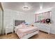 Cozy bedroom with a pink comforter, white dresser and nightstand, and a gray headboard at 8501 W Glenrosa Ave, Phoenix, AZ 85037