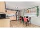 Bright kitchen with light wood cabinets, stainless steel appliances, and a small dining area at 8501 W Glenrosa Ave, Phoenix, AZ 85037