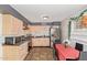 Bright kitchen with light wood cabinets, stainless steel appliances, and a small dining area at 8501 W Glenrosa Ave, Phoenix, AZ 85037