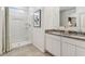 Bright bathroom featuring a dual sink vanity with granite counters and a shower at 8517 W Mantle Way, Florence, AZ 85132