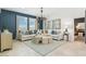 Stylish living room featuring tile flooring, a modern chandelier, and a comfortable sectional sofa at 8517 W Mantle Way, Florence, AZ 85132