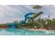 View of the pool featuring a waterslide, seating, and shade umbrellas at 8517 W Mantle Way, Florence, AZ 85132