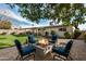 Relaxing backyard with fire pit, patio furniture, putting green, and covered patio at 8620 E Starlight Way, Scottsdale, AZ 85250