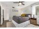 Cozy bedroom with gray bedding and ceiling fan at 8620 E Starlight Way, Scottsdale, AZ 85250