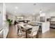 Open concept dining area with kitchen island and hardwood floors at 8620 E Starlight Way, Scottsdale, AZ 85250