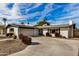 Single story home with a two-car garage and well-manicured lawn at 8620 E Starlight Way, Scottsdale, AZ 85250