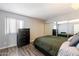 Guest bedroom with a full-size bed and mirrored closet doors at 9275 E Mission Ln # 207, Scottsdale, AZ 85258