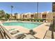 Community pool with ample deck space and lounge chairs at 9275 E Mission Ln # 207, Scottsdale, AZ 85258