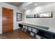 Modern entryway with wood flooring, built-in storage, and a sleek wood door at 100 W Portland St # 401, Phoenix, AZ 85003