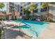 Community pool with plenty of lounge chairs and surrounding landscaping at 100 W Portland St # 401, Phoenix, AZ 85003