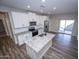 Modern kitchen with white cabinets, granite counters and island at 11472 W Cumberland Dr, Youngtown, AZ 85363