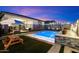 The home's backyard features a beautifully lit pool, perfect for evening entertaining or tranquil relaxation at 11517 E Unity Ave, Mesa, AZ 85212