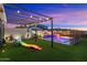 Backyard with lush artificial grass and playful amenities at 11517 E Unity Ave, Mesa, AZ 85212