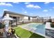 This fenced backyard showcases a modern pool, artificial turf, and a patio for outdoor enjoyment at 11517 E Unity Ave, Mesa, AZ 85212