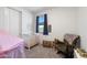 Charming Bedroom featuring a white crib, rocking chair, and plenty of natural light at 11517 E Unity Ave, Mesa, AZ 85212