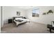 Serene bedroom featuring a minimalist design, large window, and neutral color scheme at 11517 E Unity Ave, Mesa, AZ 85212