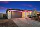 Charming home exterior featuring stylish brick driveway, two-car garage, and vibrant pink accent lights at 11517 E Unity Ave, Mesa, AZ 85212