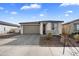 Well-maintained home featuring a two-car garage and attractive brick driveway, landscaped with desert plants at 11517 E Unity Ave, Mesa, AZ 85212