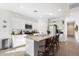 Bright kitchen features a granite island with barstool seating and stainless steel appliances at 11517 E Unity Ave, Mesa, AZ 85212