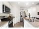 Kitchen features stainless steel appliances, granite counters and tiled flooring at 11517 E Unity Ave, Mesa, AZ 85212