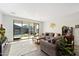 Open concept living room with neutral colors and sliding glass door to backyard at 11517 E Unity Ave, Mesa, AZ 85212