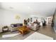 Open concept living room with neutral colors and view into kitchen and dining room at 11517 E Unity Ave, Mesa, AZ 85212