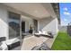 Covered patio with sleek outdoor furniture and stone flooring offers a seamless indoor-outdoor living experience at 11517 E Unity Ave, Mesa, AZ 85212