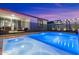 The pool is illuminated at dusk, creating an inviting ambiance for evening swims and relaxation at 11517 E Unity Ave, Mesa, AZ 85212