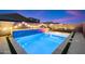 Sparkling pool with colored lights and a relaxing atmosphere at 11517 E Unity Ave, Mesa, AZ 85212