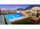 Backyard pool with lights and sitting area, perfect for relaxing and entertaining at 11517 E Unity Ave, Mesa, AZ 85212