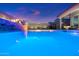 The outdoor water feature and lights add a touch of elegance to this mesmerizing backyard pool area at 11517 E Unity Ave, Mesa, AZ 85212