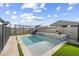 This backyard boasts a stunning pool with a stone accent wall, perfect for relaxation and entertainment at 11517 E Unity Ave, Mesa, AZ 85212