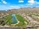 Aerial view of houses, golf course, and lake in a residential community at 12129 N 114Th Way, Scottsdale, AZ 85259