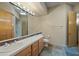 Bathroom with double sinks, shower, and tile flooring at 12129 N 114Th Way, Scottsdale, AZ 85259